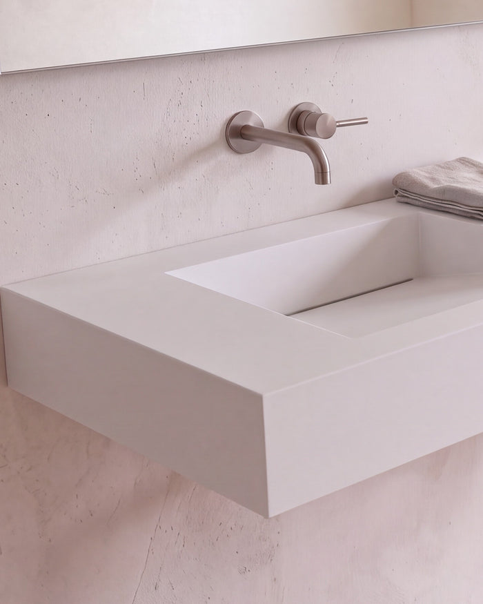 Badeloft details portrait 2026: matte white stone resin, basin cast into the slab as one piece