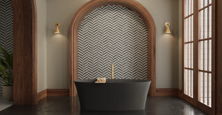 Matte black freestanding tub in a bathroom with dark walls and a large window