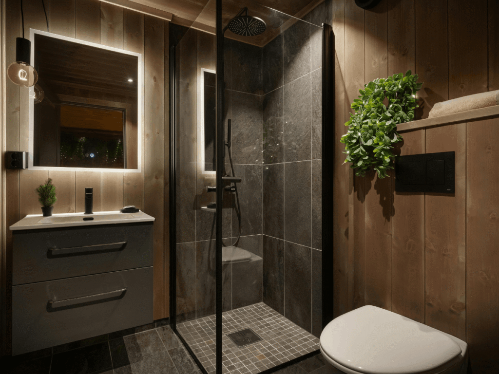 Wood clad bathroom with a large slate walk-in shower and wall hung toilet