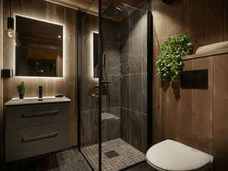 Wood clad bathroom with a large slate walk-in shower and wall hung toilet