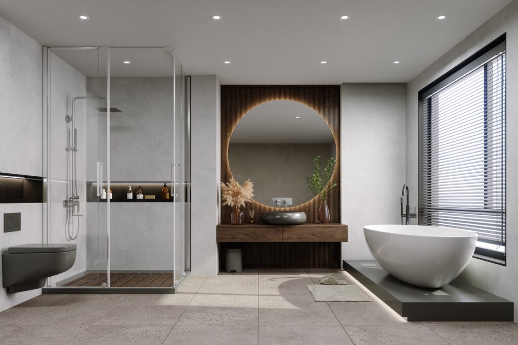 Modern bathroom with a glass shower, vessel tub and round mirror