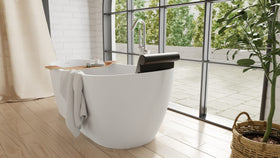 Badeloft BR-01 matte black bathtub backrest installed in a white freestanding tub, bright side view