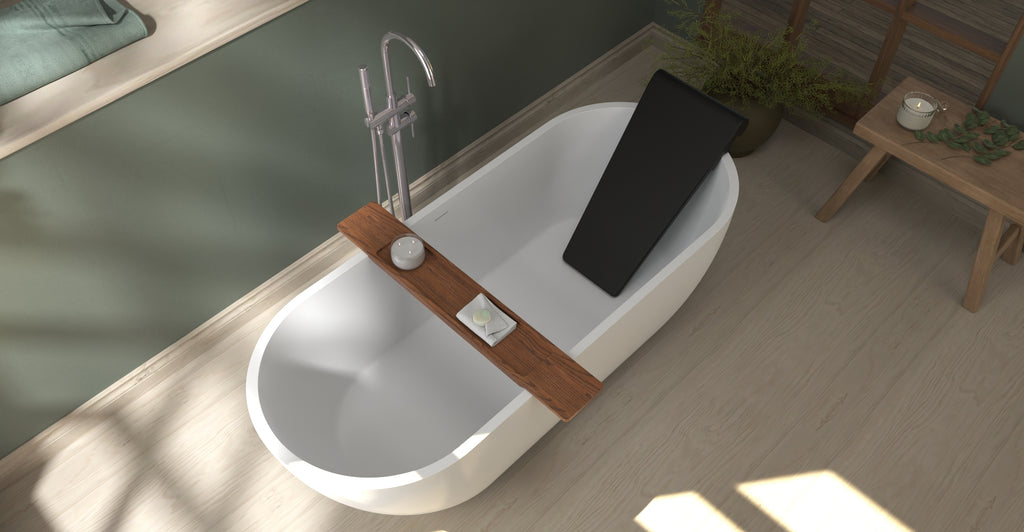 Badeloft BR-01 matte black bathtub backrest installed in a white freestanding tub, overhead green bathroom view