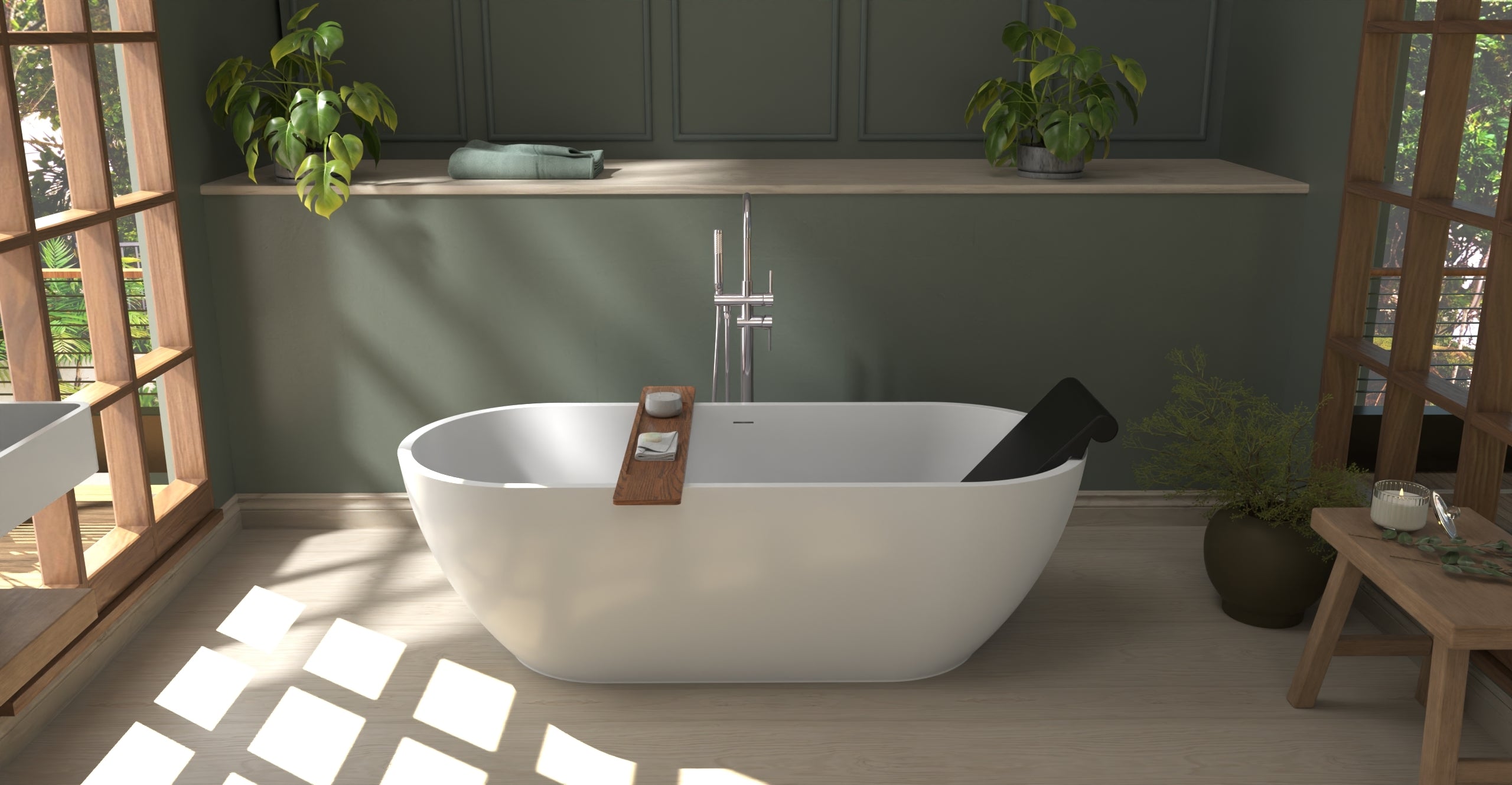 Badeloft BR-01 matte black bathtub backrest installed in a white freestanding tub, sunlit green bathroom view