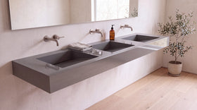 90" ADA Triple Ramp Sink, Wall Mounted in glossy grey stone resin, wall mounted in a bright bathroom