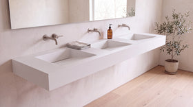 90" ADA Triple Ramp Sink, Wall Mounted in matte white stone resin, wall mounted in a bright bathroom