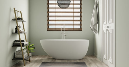 Badeloft BW-01-S freestanding bathtub in matte white in a sage green bathroom with a ladder shelf and window blinds