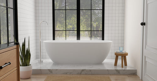 Badeloft BW-02-XL freestanding bathtub in matte white on a raised marble platform with square wall tile and paned windows