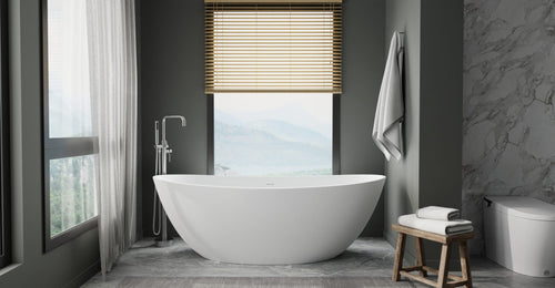 Badeloft BW-03-XL freestanding bathtub in matte white by a tall window with a mountain view, a wood stool and dark walls