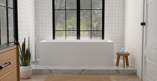 Badeloft BW-06-XL freestanding bathtub in matte white on a raised marble platform with square wall tile and paned windows