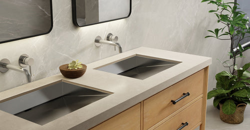 Two Badeloft ES-UB-04-M ramp sinks in brushed steel under a stone counter on a wood vanity with wall-mounted faucets