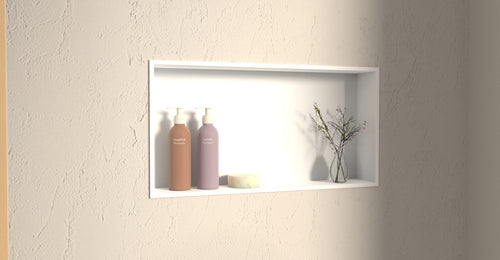 Badeloft NS-03 shower niche in matte white set into a plaster wall with bottles and dried flowers