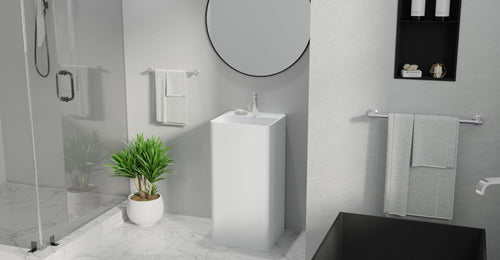 Badeloft SB-01-A freestanding sink in matte white in a marble-look bathroom with a round mirror, beside a glass shower