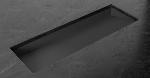 Badeloft UB-04-XL stone resin undermount ramp sink in matte black, set into a dark stone counter, angled view