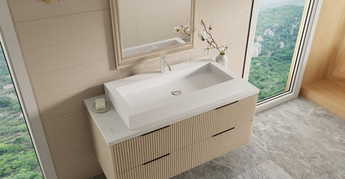 Badeloft WB-05-XL countertop sink in matte white on a fluted wood floating vanity by a window with a mountain view