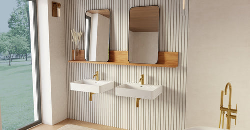 Two Badeloft WT-01-M wall-mounted sinks in matte white on a fluted wall below a wood shelf and two mirrors, by a tall window
