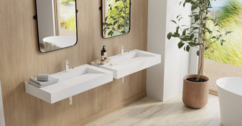 Two Badeloft WT-04-B wall-mounted sinks in matte white on a wood-panel wall with two mirrors, by a tree and a garden window